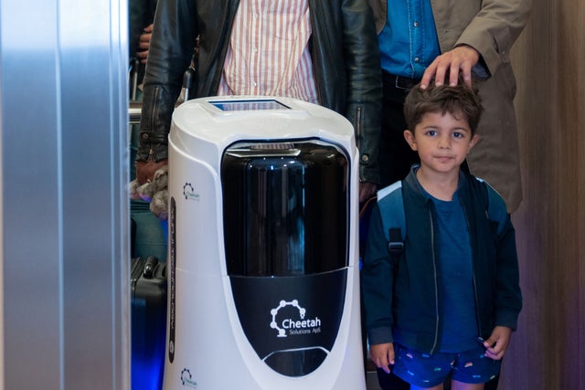 Young boy with parents in an elevator with a robot