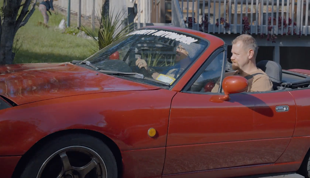 Christopher Platt and Bo Liu in a red car
