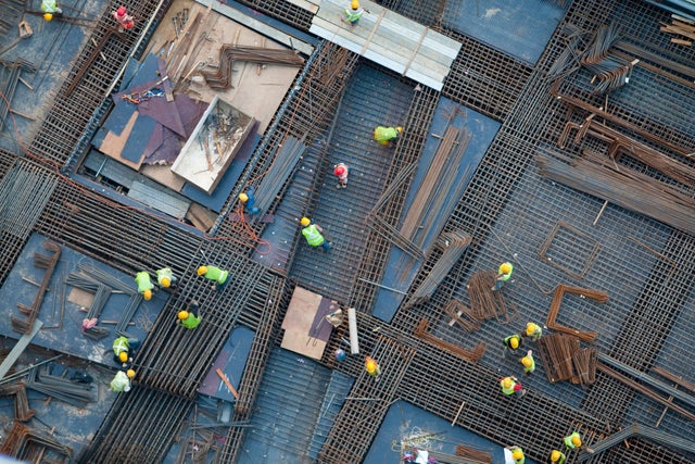 Construction workers working on a roof.