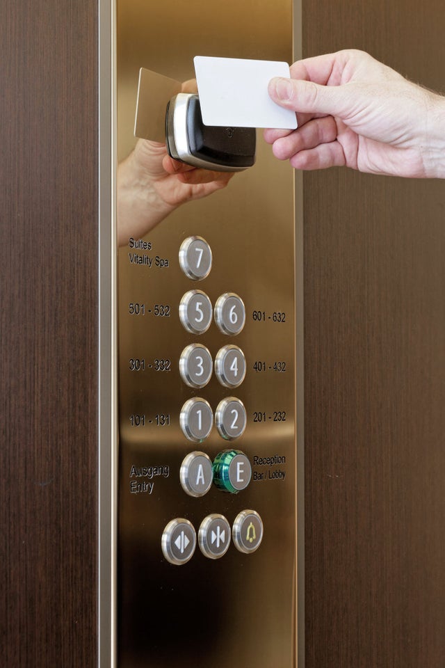 key card shown to reader in elevator