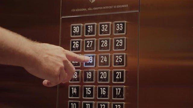 hand pressing elevator button