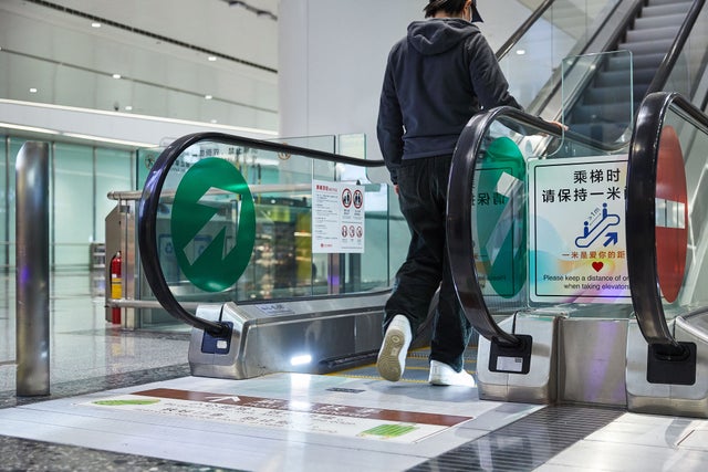 Man on escalator at Beijing Daxing Airport