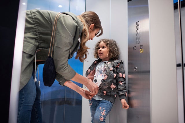 women and kid in elevator