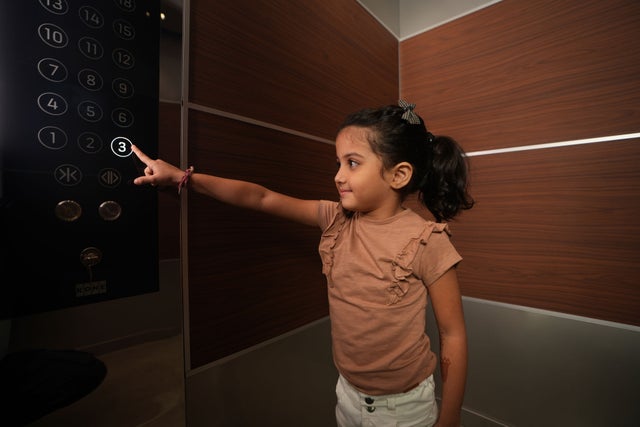 Girl Using Elevator Panel
