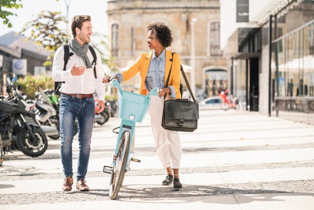 Two people in the city with bikes