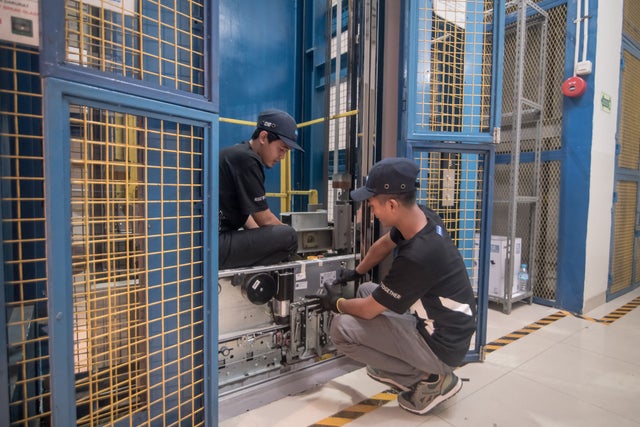 Two technicians practicing at the KONE Indonesia training center