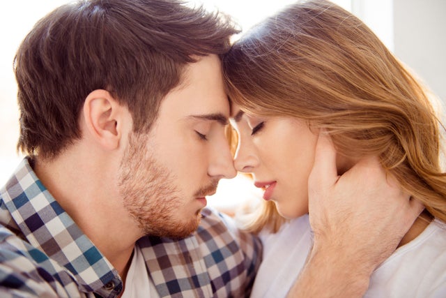 A man and a woman placing their heads together.