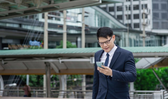 Man looking at a phone outside
