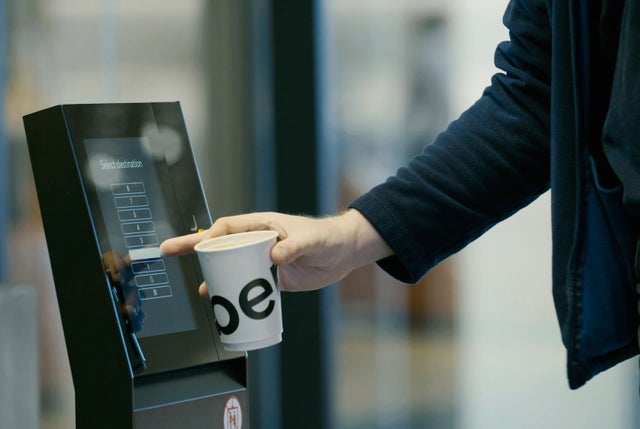 Person operating a touch screen to order an elevator