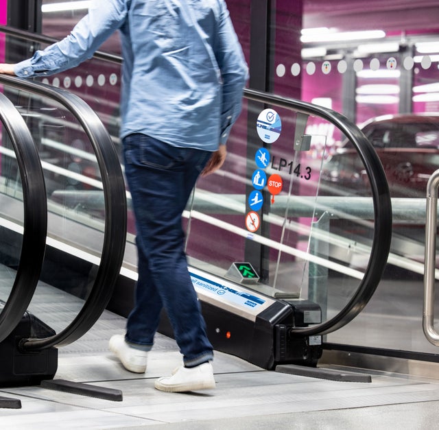 Person walking into an escalator