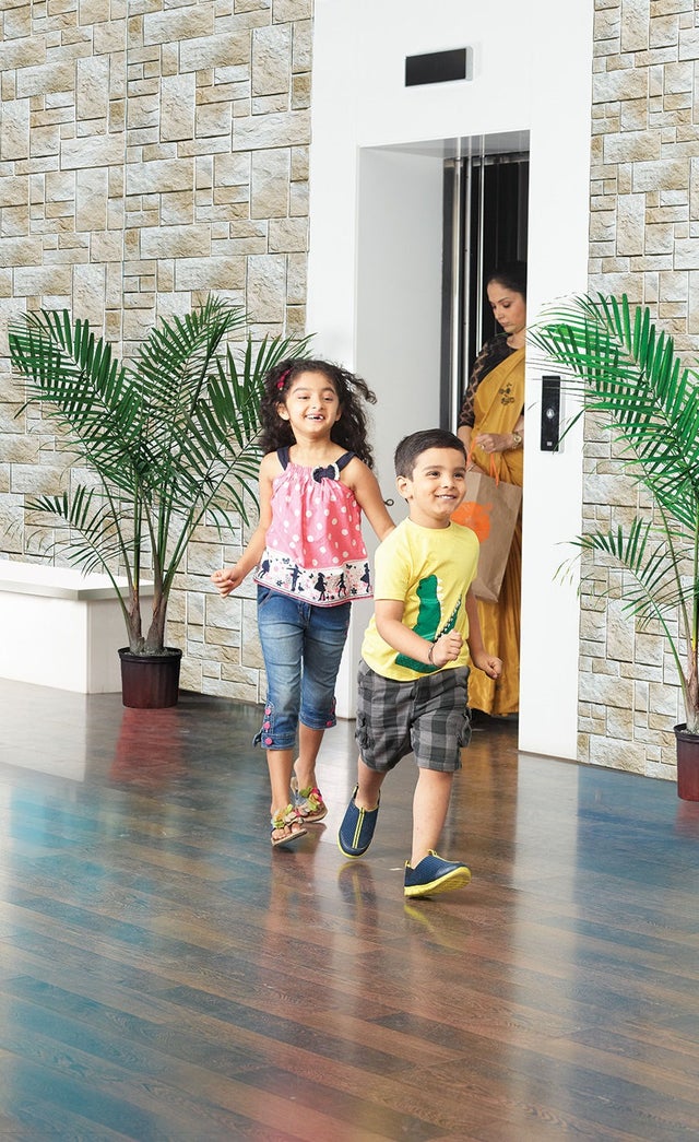 KONE technician and customer in elevator lobby