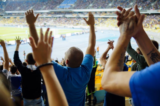 Audience cheering at a sports arena.