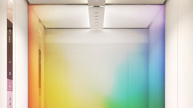 An elevator lit with a full spectrum of colours.