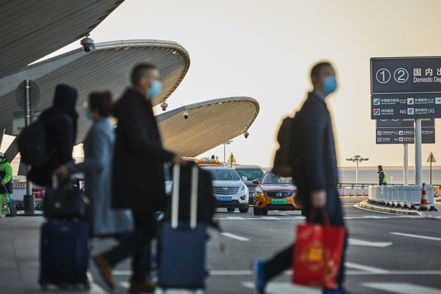 People walking outside Beijing Daxing Airport