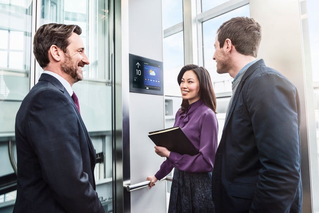 people in the elevator smiling, partnership
