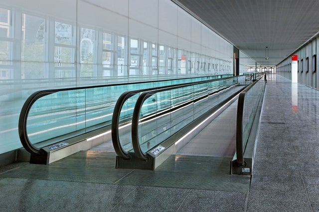 Travellers coming off a moving walk