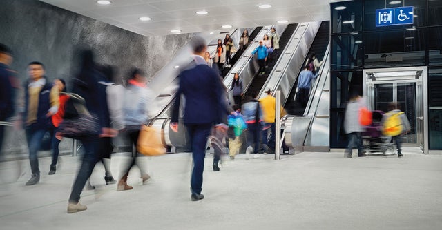 People walking, escalators and elevators in the background