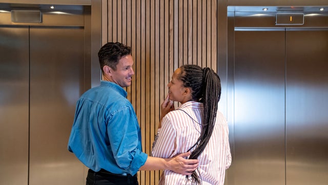 Man and woman waiting for an elevator