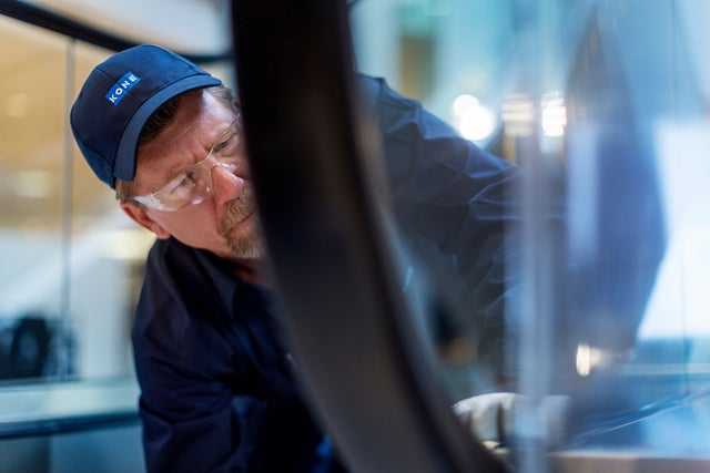 KONE technician working on an escalator