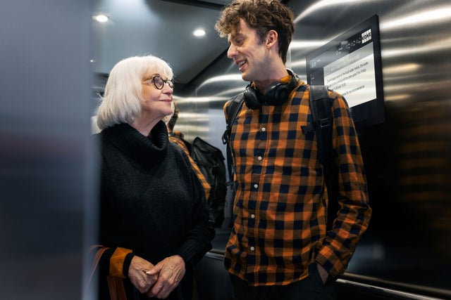 old woman and a man inside elevator