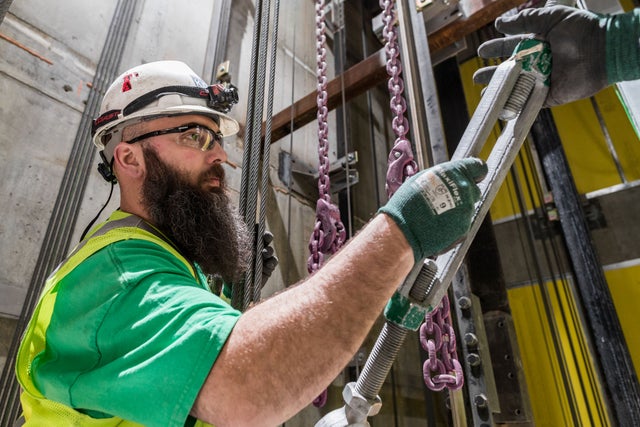  technician fixing an elevator