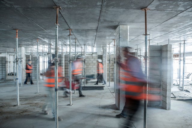 construction site with moving workers