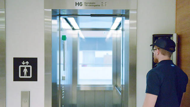 KONE technician in front of an elevator.