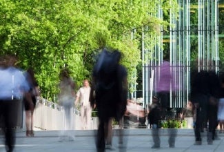 People in front of a building and trees