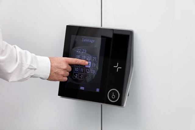 hand pressing KONE Destination control system panel