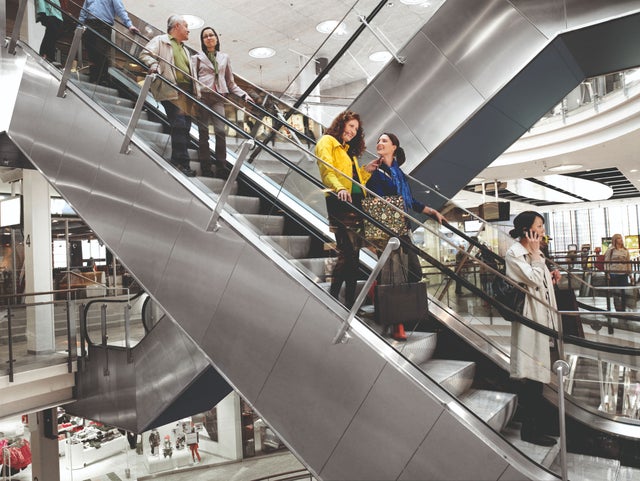 People travalling on an escalator in shopping center