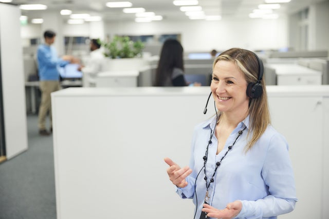 Woman at an offie with headphones