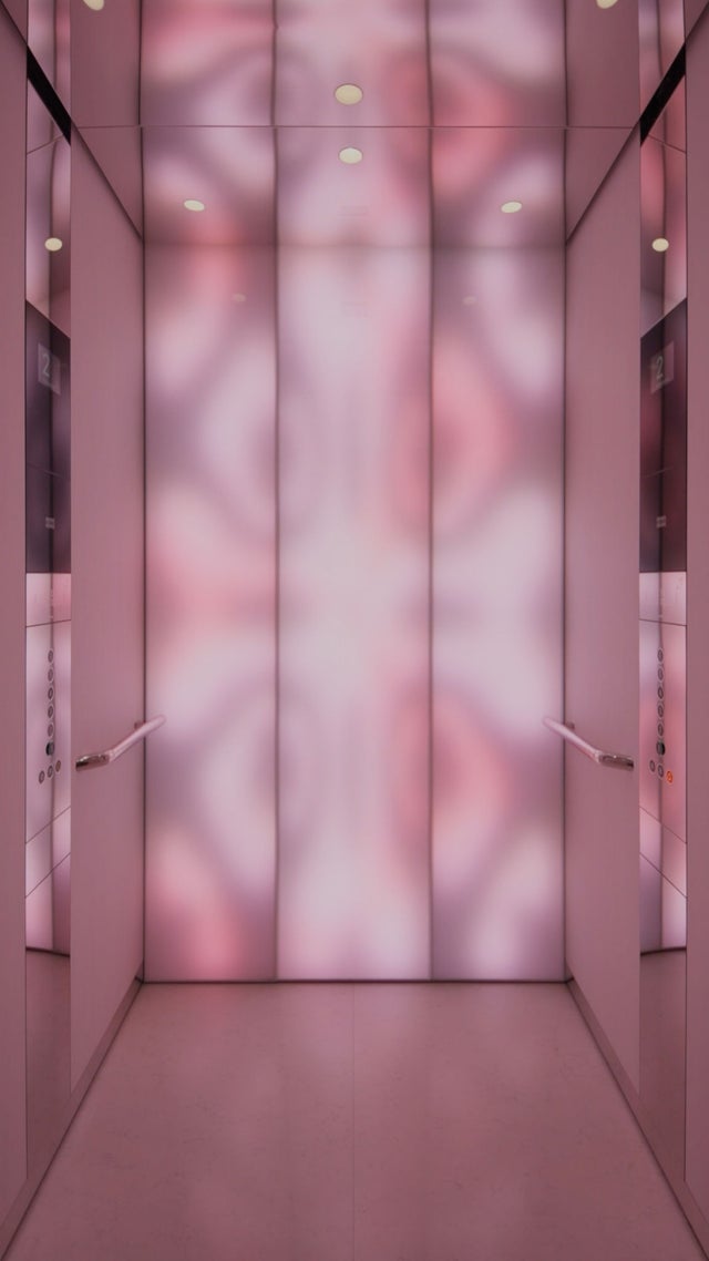 Woman in a Digital Experience Car with soft pink visuality