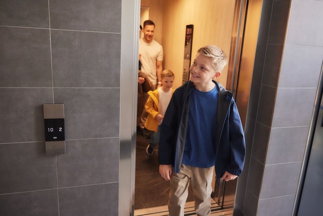 A family walking out of an elevator