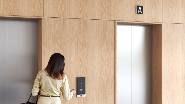 Woman calling an elevator