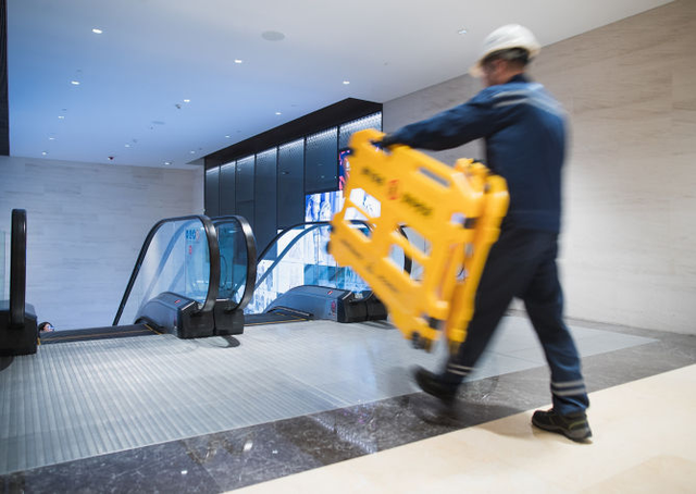 escalator maintenance barrier carried in place