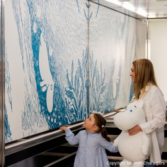 Mother and child in a KONE Moomin elevator