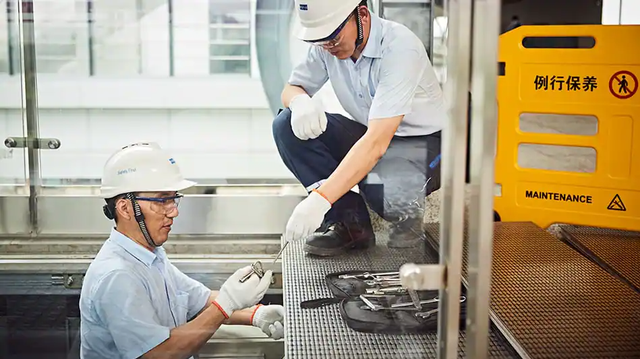 Two technicians doing maintenance work to an escalator.