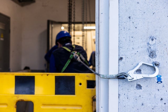 Technician behind safety barrier