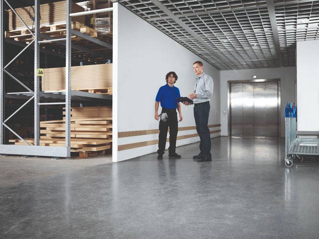Warehouse with two men standing in front of an elevator