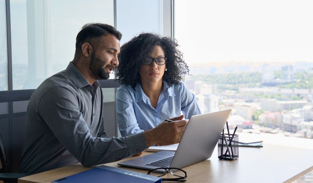Man and woman looking at a computer