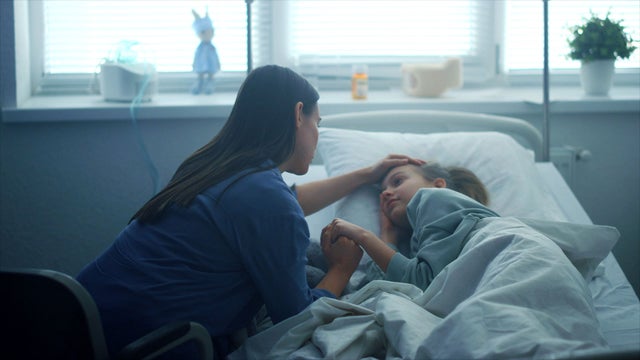 Mother with child in hospital bed