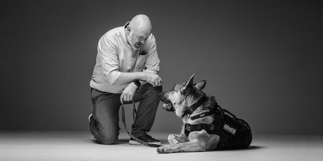 A man and a German shepherd 