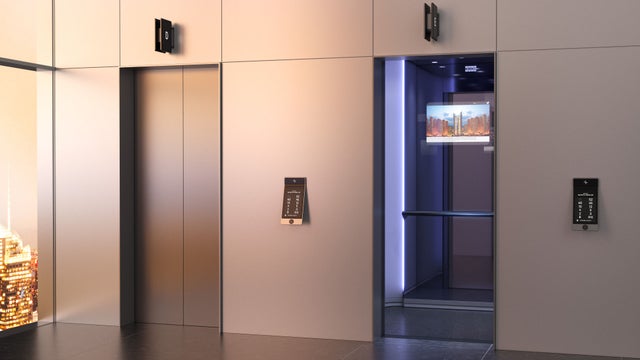 Lobby with one elevator with doors open showing a screen