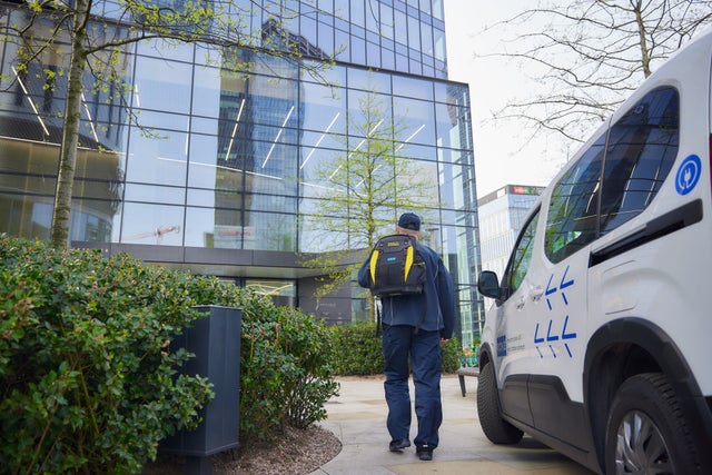 KONE technician walking towards a building