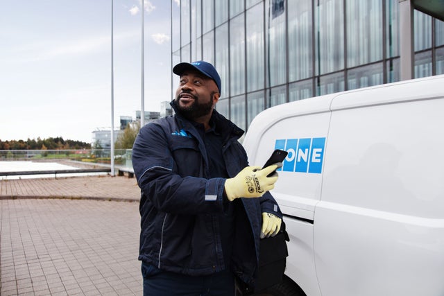 KONE technician by a car