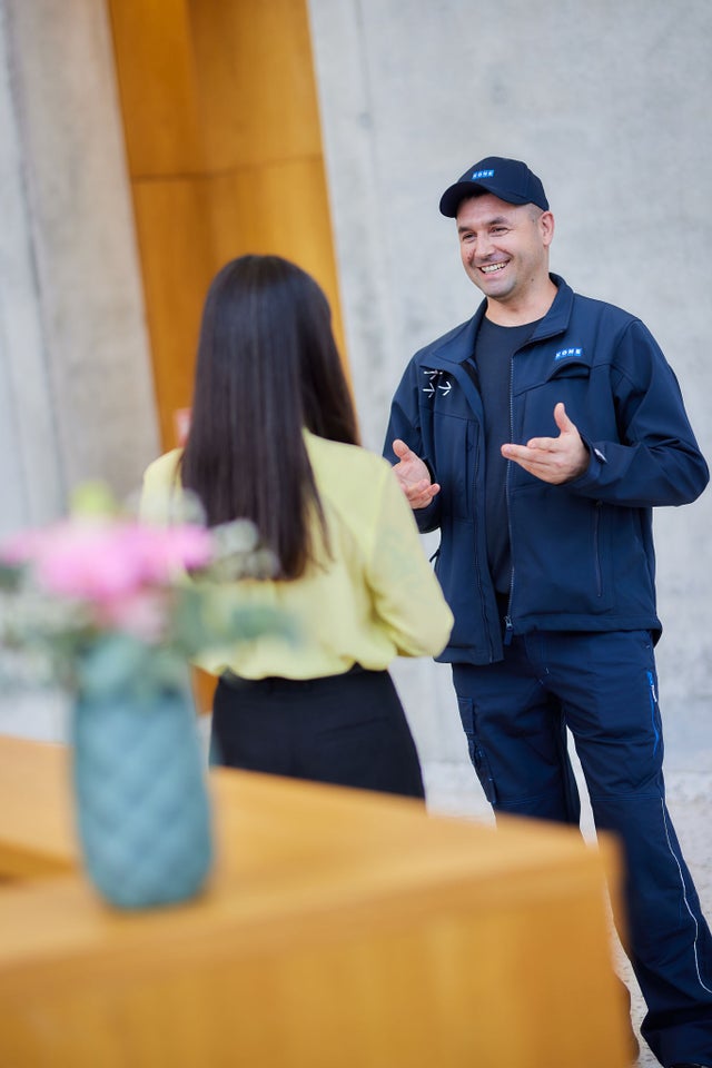 KONE technician discussing with a customer