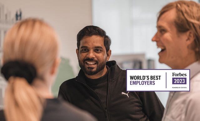 A happy man talking to two other people