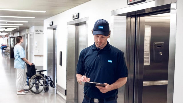 KONE technician in front of an elevator