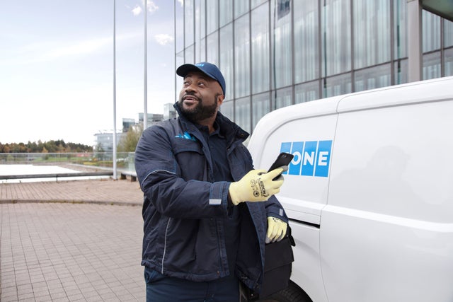 KONE technician by a car