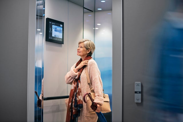Elderly lady inside elevator